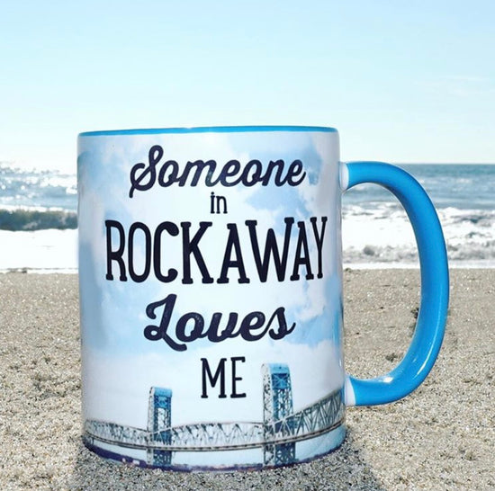 Rockaway Beach mug, someone in Rockaway loves me print on a bridge backdrop with a blue handle and interior, handmade mug, handmade gifts made in Brooklyn NY 